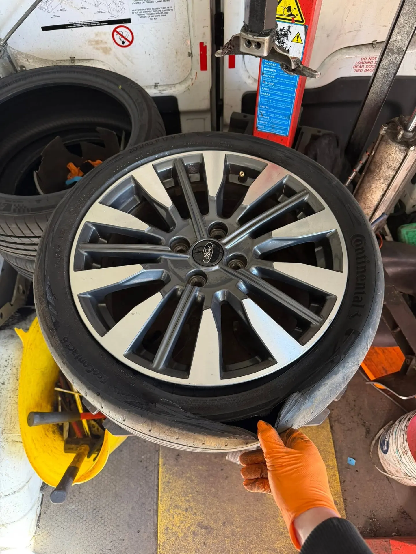 Tyre on the fitting machine inside the van